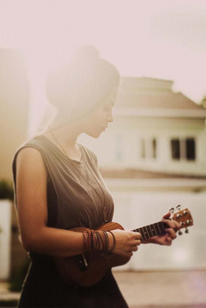 hazy image of a woman playing the ukulele.